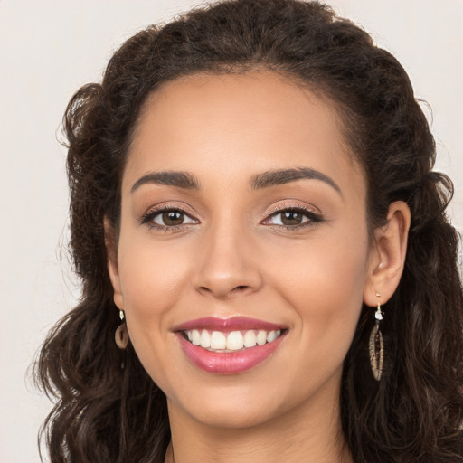 Joyful white young-adult female with long  brown hair and brown eyes