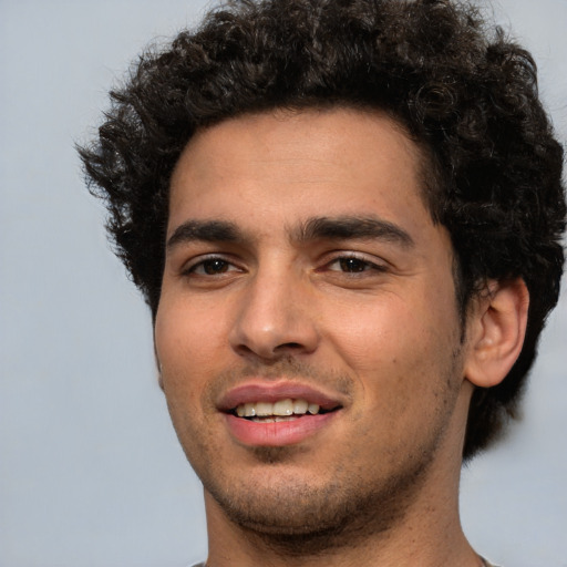 Joyful white young-adult male with short  black hair and brown eyes