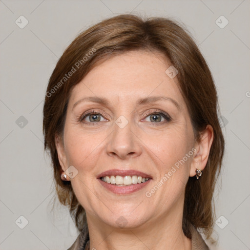 Joyful white adult female with medium  brown hair and grey eyes