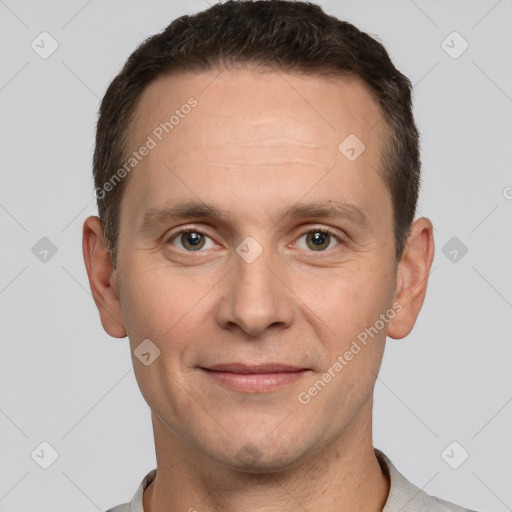 Joyful white adult male with short  brown hair and grey eyes