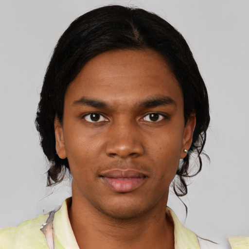Joyful black young-adult male with short  black hair and brown eyes