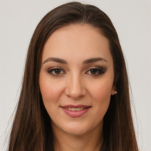 Joyful white young-adult female with long  brown hair and brown eyes