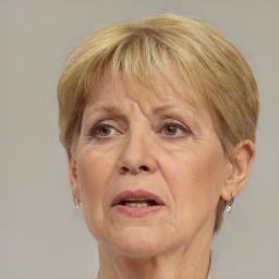 Joyful white middle-aged female with short  blond hair and brown eyes