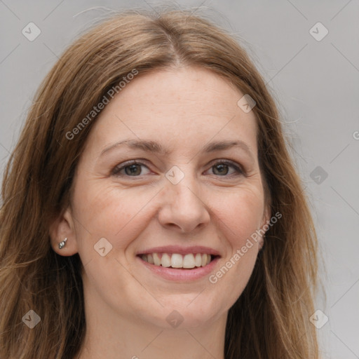 Joyful white adult female with long  brown hair and grey eyes