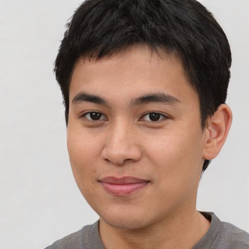 Joyful asian young-adult male with short  brown hair and brown eyes