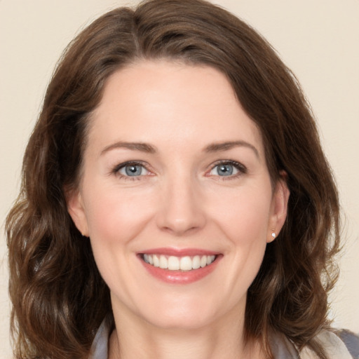 Joyful white young-adult female with medium  brown hair and green eyes