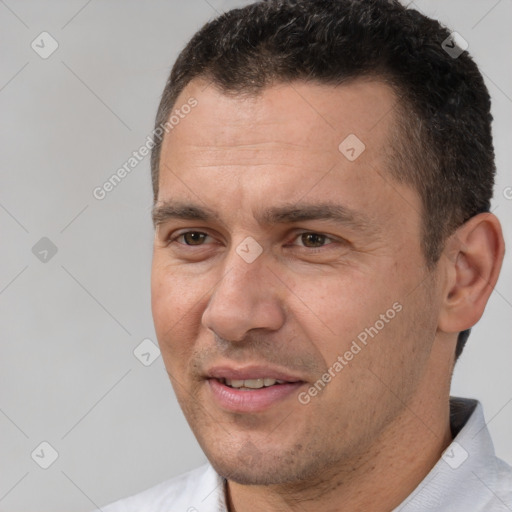 Joyful white adult male with short  brown hair and brown eyes