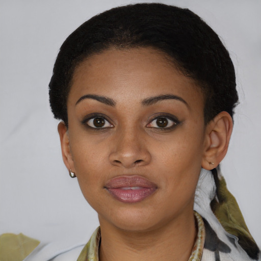 Joyful black young-adult female with short  brown hair and brown eyes