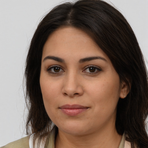 Joyful latino young-adult female with long  brown hair and brown eyes