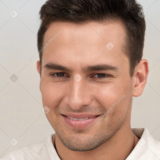 Joyful white young-adult male with short  brown hair and brown eyes