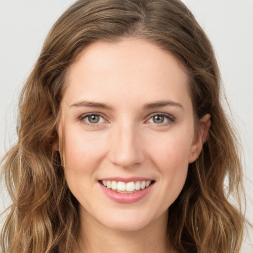 Joyful white young-adult female with long  brown hair and green eyes