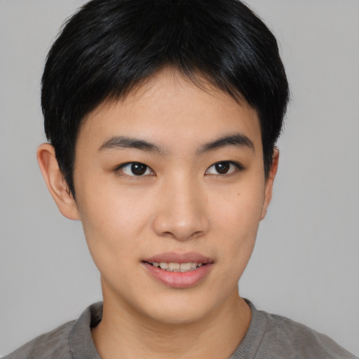 Joyful asian young-adult male with short  brown hair and brown eyes
