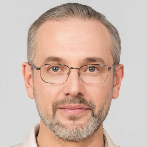 Joyful white middle-aged male with short  gray hair and brown eyes