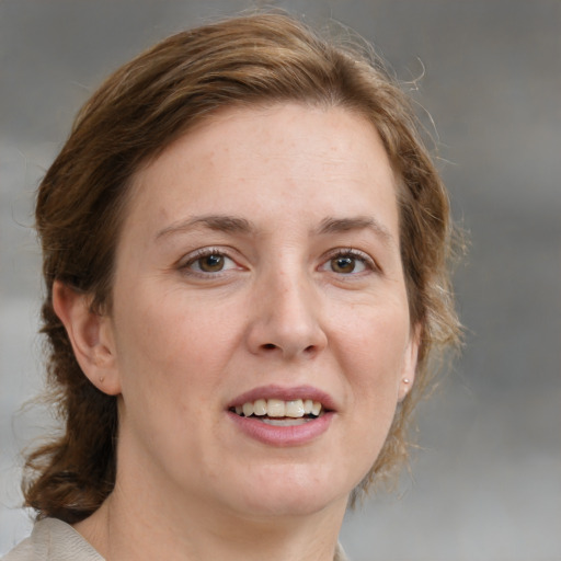 Joyful white adult female with medium  brown hair and blue eyes