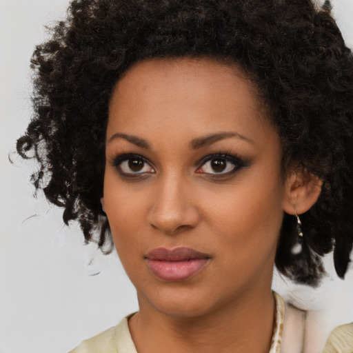 Joyful black young-adult female with medium  brown hair and brown eyes
