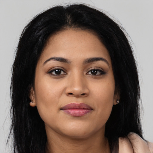 Joyful latino young-adult female with long  brown hair and brown eyes
