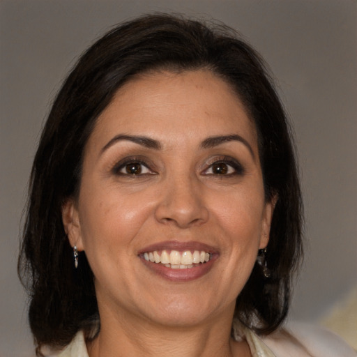 Joyful white adult female with medium  brown hair and brown eyes