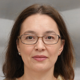 Joyful white adult female with medium  brown hair and grey eyes