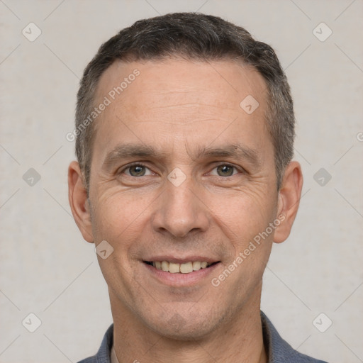 Joyful white adult male with short  brown hair and brown eyes