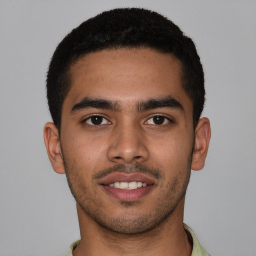 Joyful latino young-adult male with short  brown hair and brown eyes