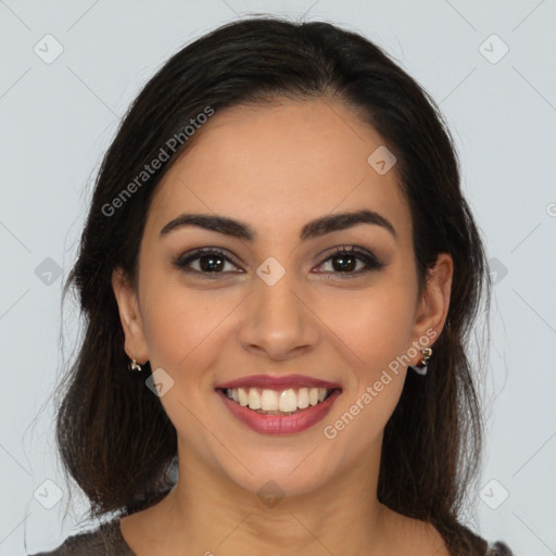 Joyful latino young-adult female with long  brown hair and brown eyes