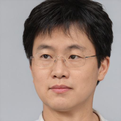 Joyful asian adult male with short  brown hair and brown eyes