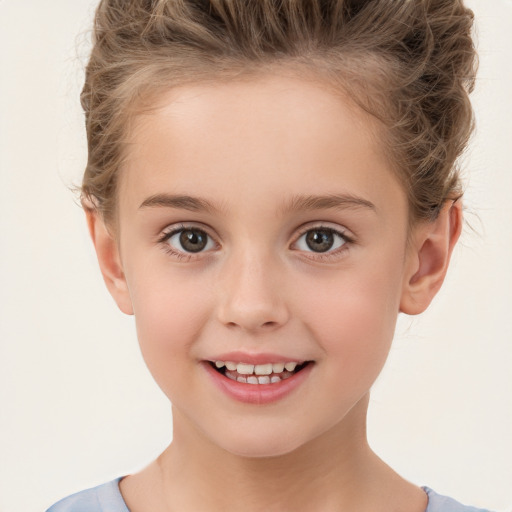 Joyful white child female with short  brown hair and brown eyes