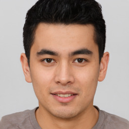 Joyful asian young-adult male with short  black hair and brown eyes