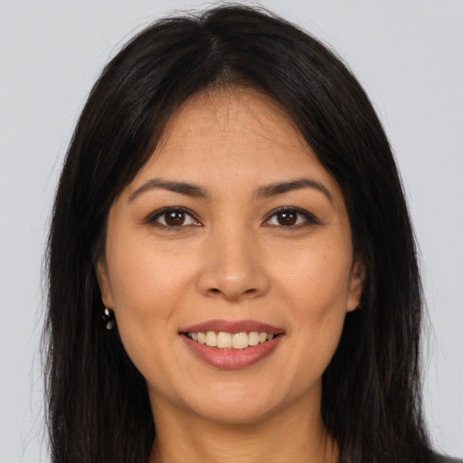 Joyful asian young-adult female with long  brown hair and brown eyes