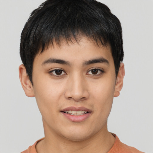 Joyful asian young-adult male with short  brown hair and brown eyes