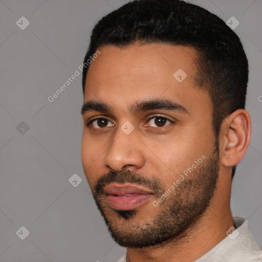 Joyful latino young-adult male with short  black hair and brown eyes