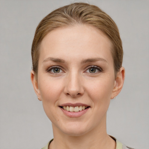 Joyful white young-adult female with short  brown hair and grey eyes