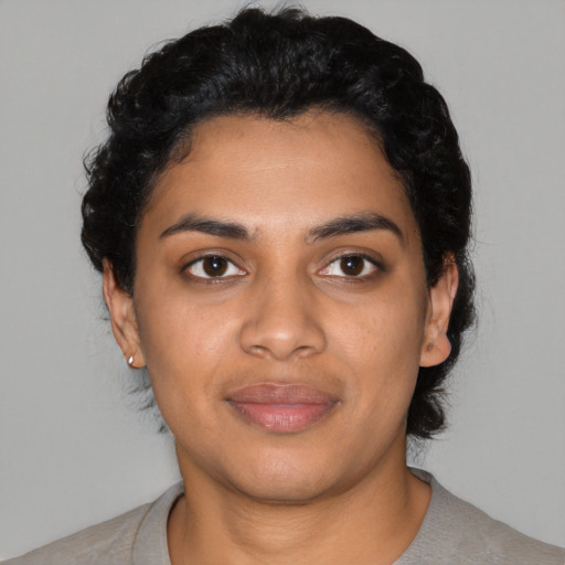 Joyful latino young-adult female with short  black hair and brown eyes