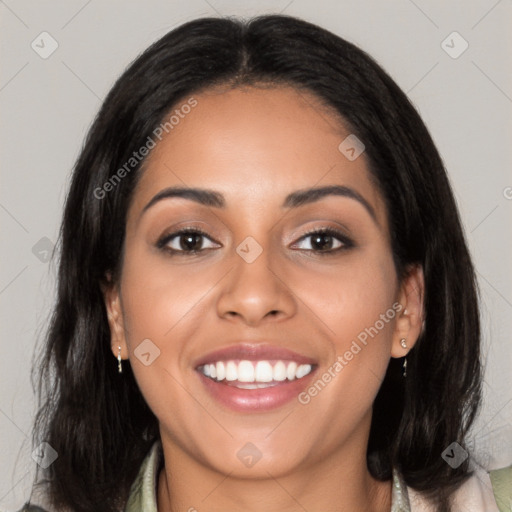 Joyful latino young-adult female with long  black hair and brown eyes