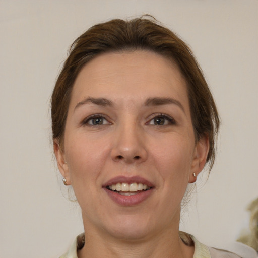 Joyful white adult female with medium  brown hair and brown eyes