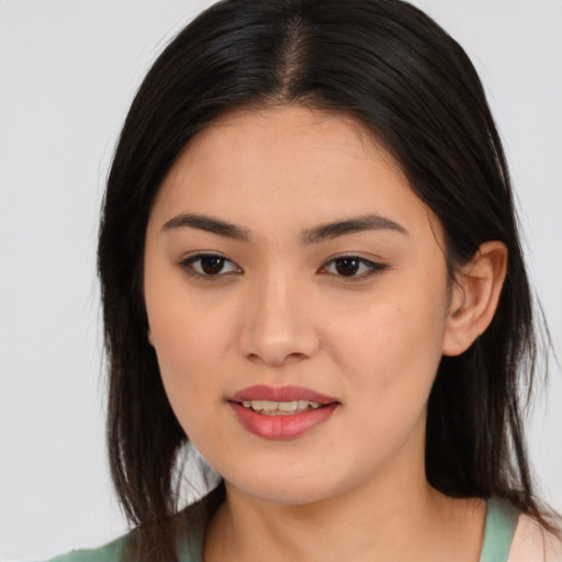 Joyful asian young-adult female with long  brown hair and brown eyes