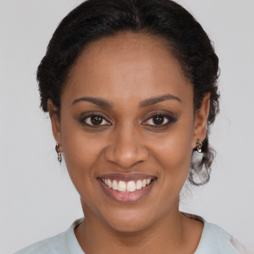 Joyful black young-adult female with short  brown hair and brown eyes
