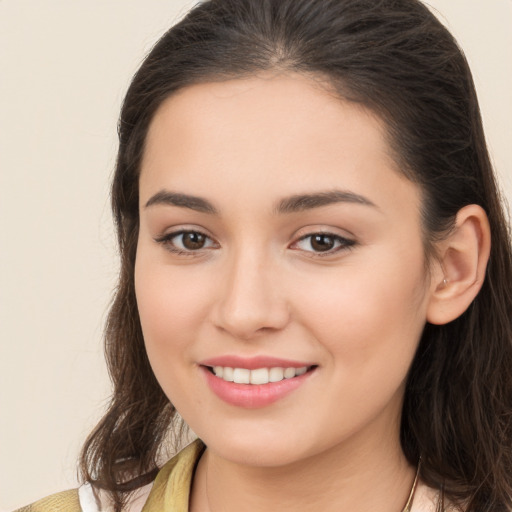 Joyful white young-adult female with long  brown hair and brown eyes