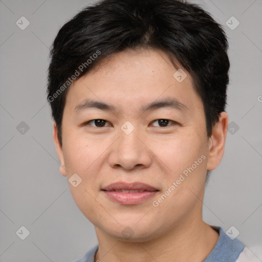 Joyful asian young-adult male with short  brown hair and brown eyes