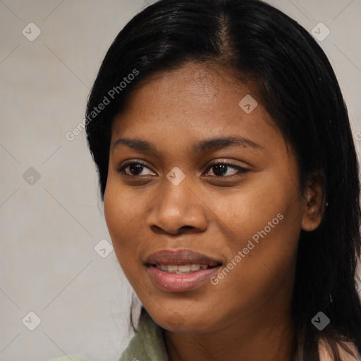 Joyful black young-adult female with long  black hair and brown eyes