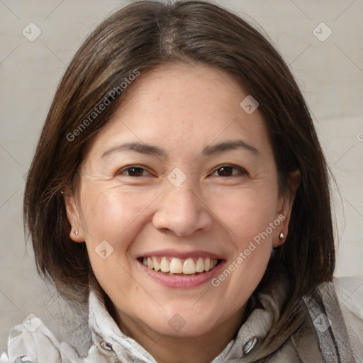 Joyful white adult female with medium  brown hair and brown eyes