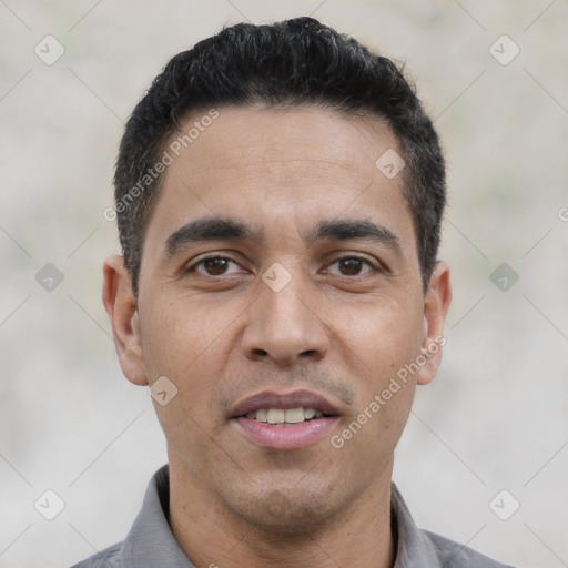 Joyful white young-adult male with short  black hair and brown eyes