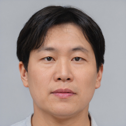 Neutral asian adult male with short  brown hair and brown eyes