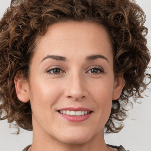 Joyful white young-adult female with medium  brown hair and green eyes