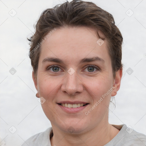 Joyful white adult female with short  brown hair and grey eyes