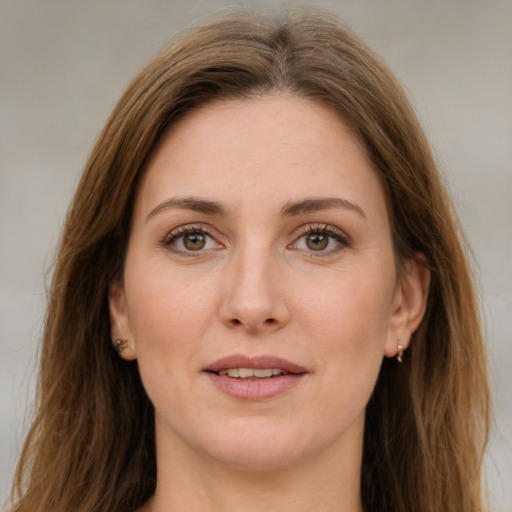 Joyful white young-adult female with long  brown hair and green eyes