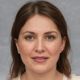 Joyful white adult female with medium  brown hair and brown eyes