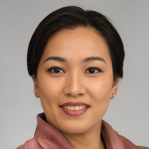 Joyful asian young-adult female with medium  black hair and brown eyes