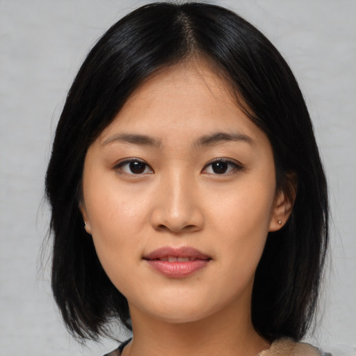 Joyful asian young-adult female with medium  black hair and brown eyes