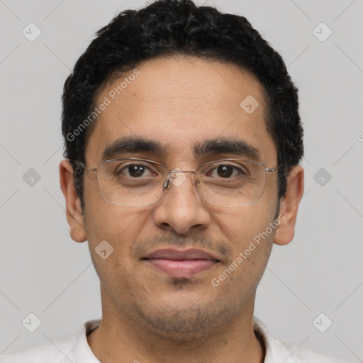 Joyful latino adult male with short  black hair and brown eyes